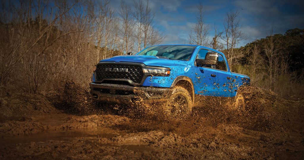 Blue Ram 1500 on a muddy road