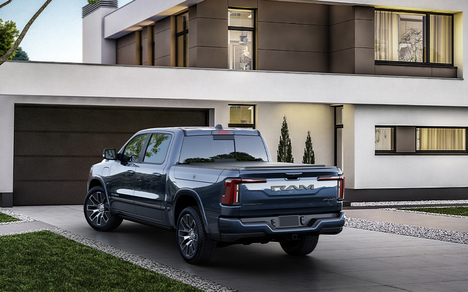 Blue Ram 1500 sitting in the driveway of a modern home