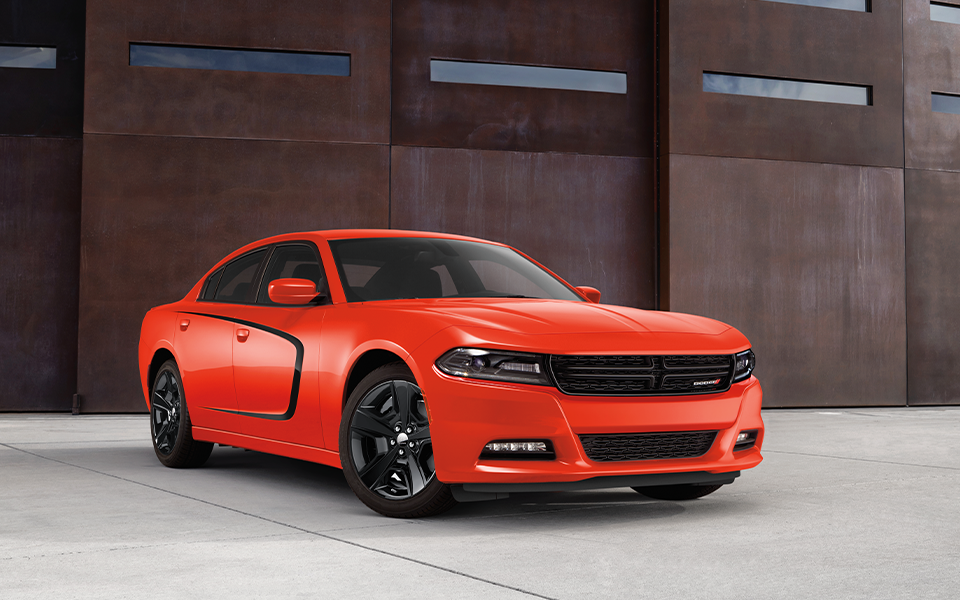 A Dodge Charger parked outside of a building