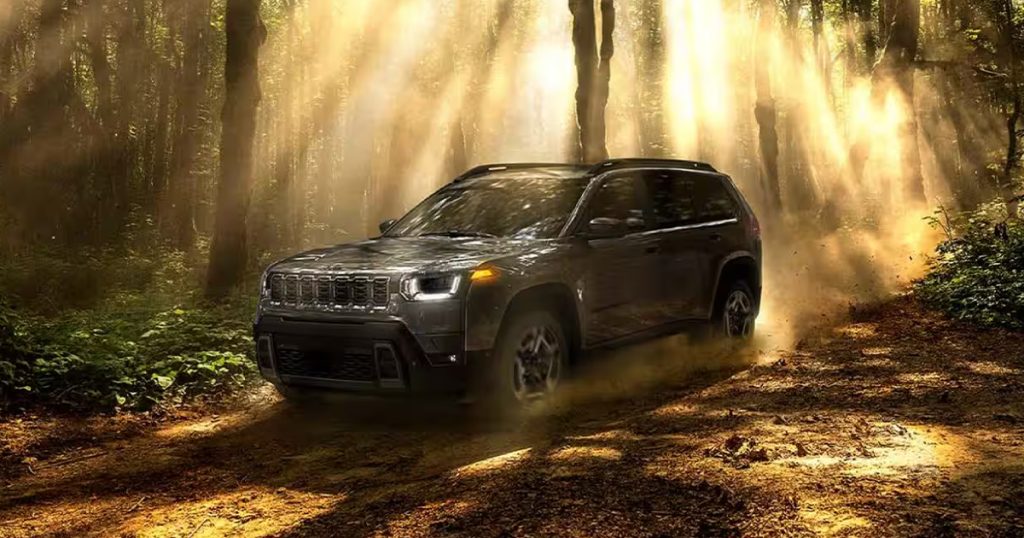 The 2026 Jeep Cherokee in a forest setting.