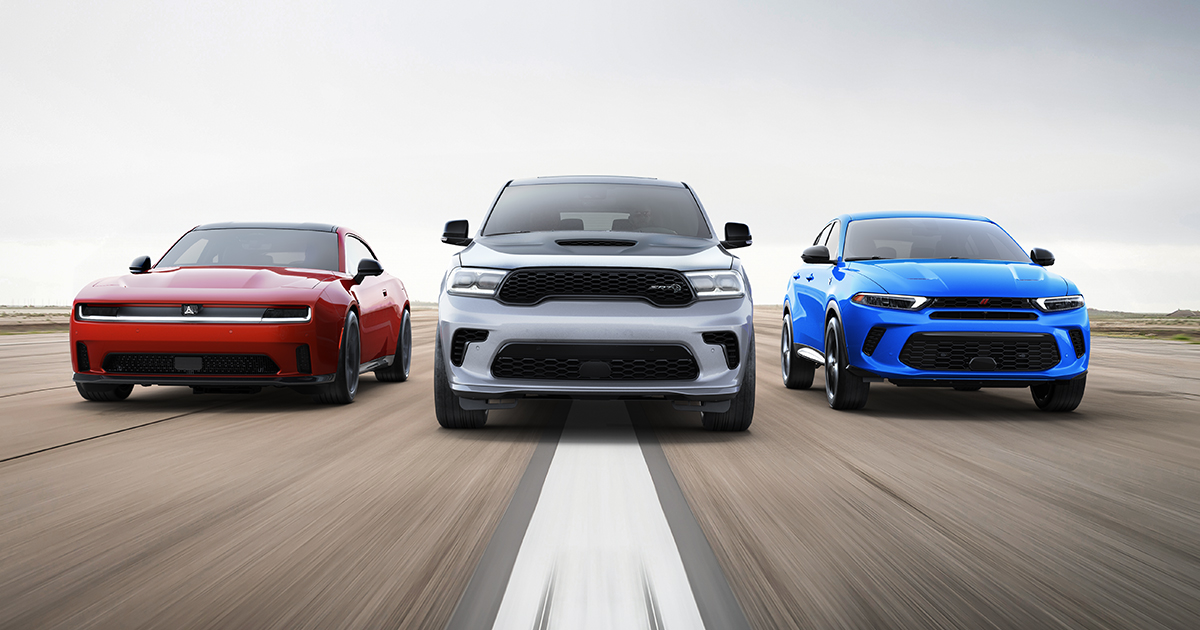 Line-up of Dodge performance models, the Dodge Charger, the Dodge Durango and a Dodge Hornet driving on a road towards the viewer